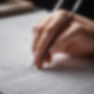 A close-up view of a hand creating delicate lines on paper.