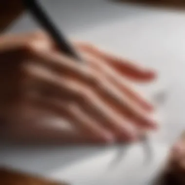 An artist's hand demonstrating shading techniques on paper