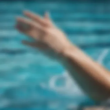 A close-up of a swimmer’s arm and hand position during the freestyle stroke.