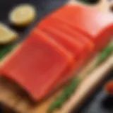 A close-up of vibrant red fish fillets on a wooden cutting board, showcasing the quality of the fish.