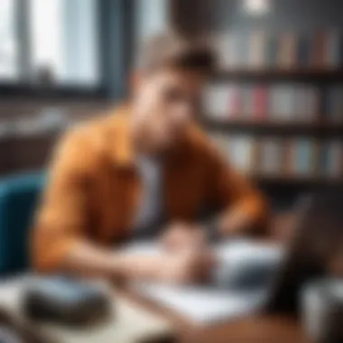 A student studying diligently at a desk with books and a laptop.