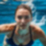 A swimmer demonstrating the freestyle stroke in clear blue water.